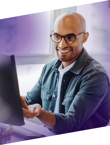 male wearing glasses working on computer