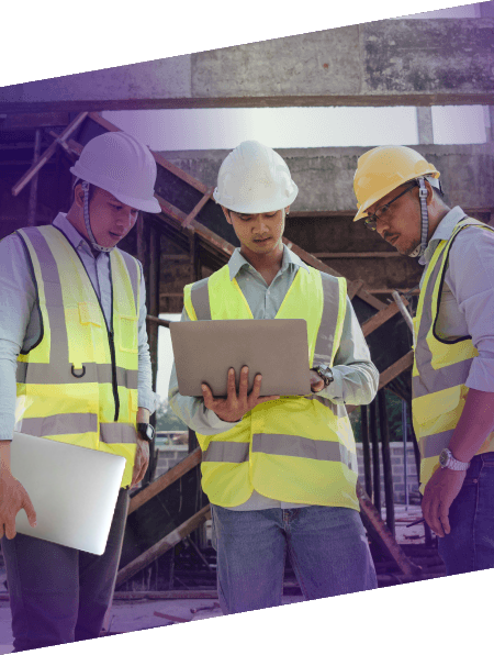 3 construction managers looking at laptop